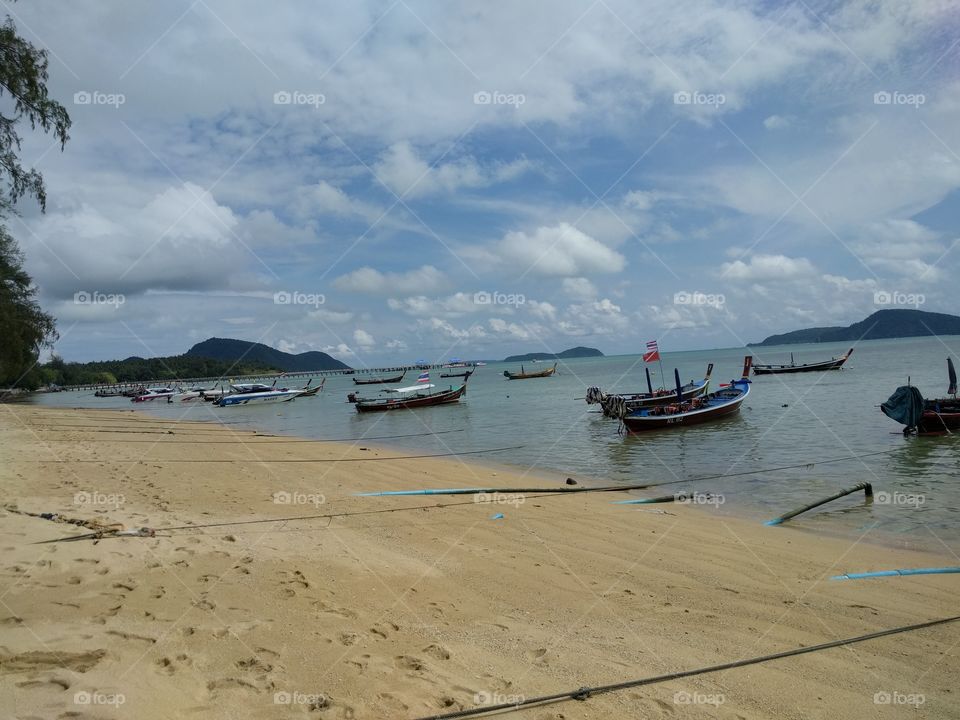 A beach with boats in thailand rawaii