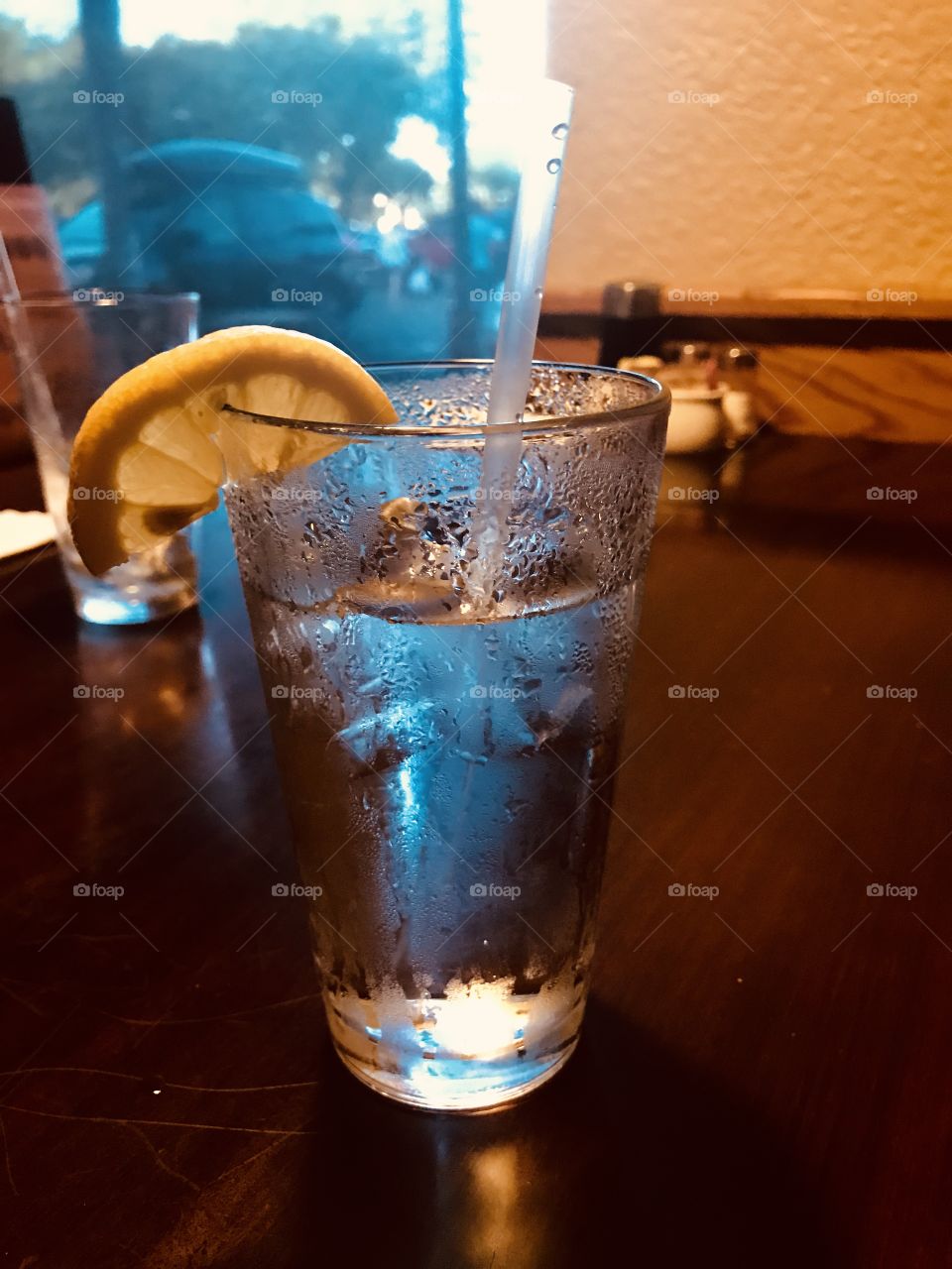 Cold fresh water with lemon on the table for dinner for two