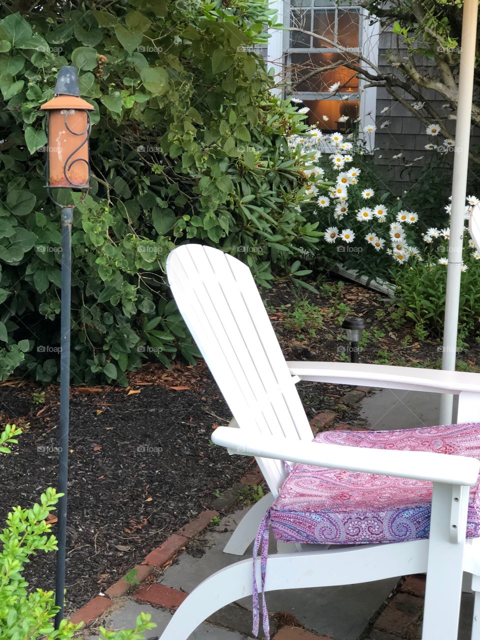 Chair on lawn with tiki torch