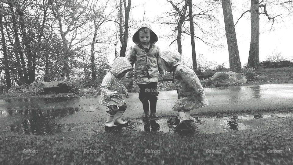 Three child playing in rainy season