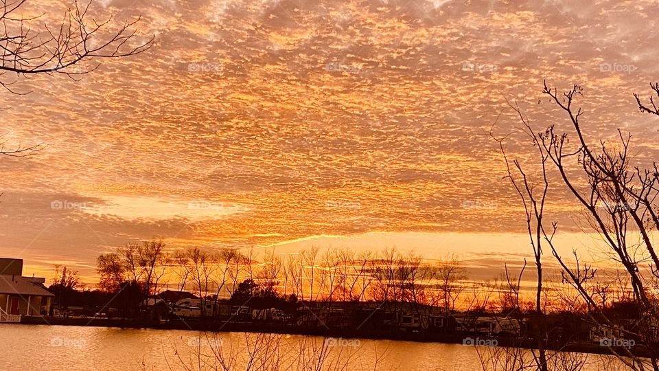 Orange Cascading Glowing Twilight Captivates the Sky as Sunset Continues to turn the Evening Sky into a huge Silhouette Glowing I the Evening Sky.