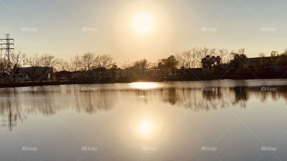 Nothing like looking straight into the Big Yellow Ball in the sky. Not a cloud in site 360. Total Reflection of the slick Lake Waters and the Landscape. Not a Ripple on the Water. Dead Calm. Silhouette Beautiful Gorgeous Captivating