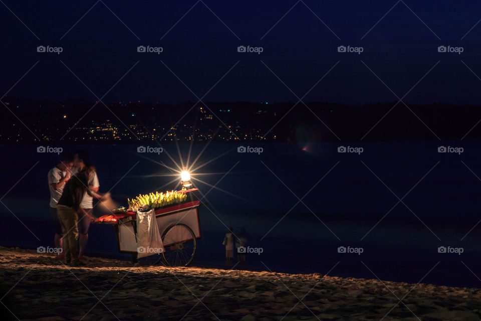 corn seller at night along beach