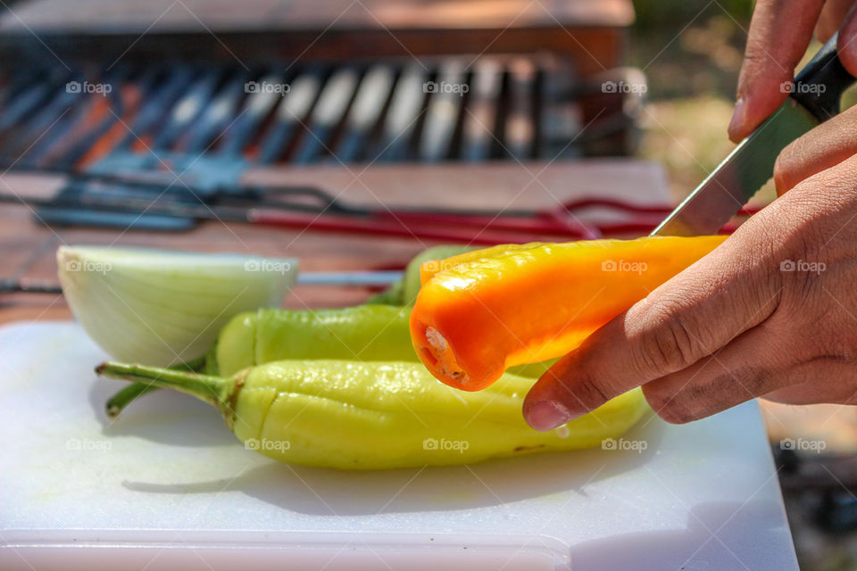 Cooking and stuffing Peppers with cheese on a camping trip