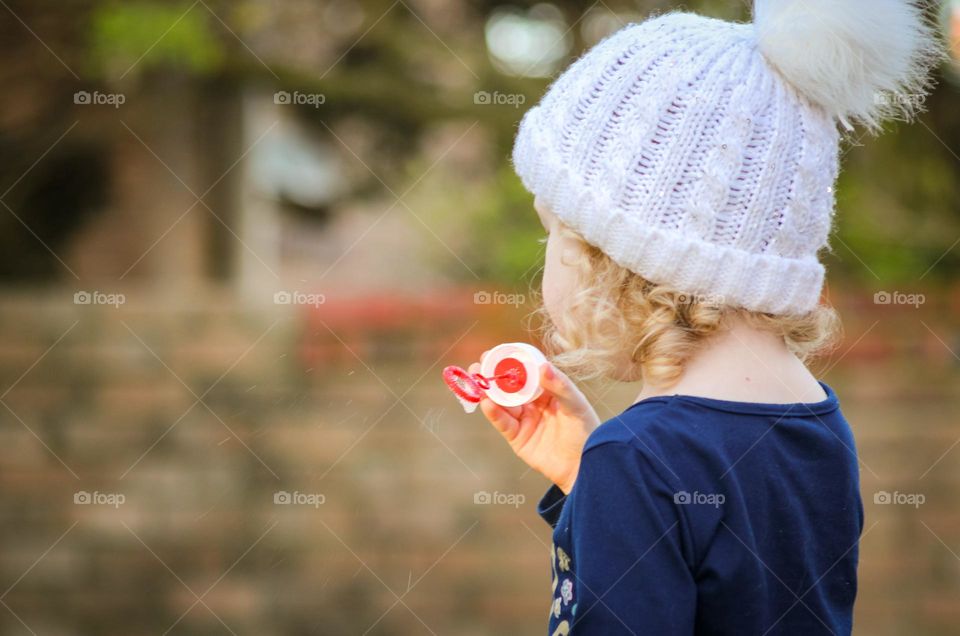 Child blowing bubbles