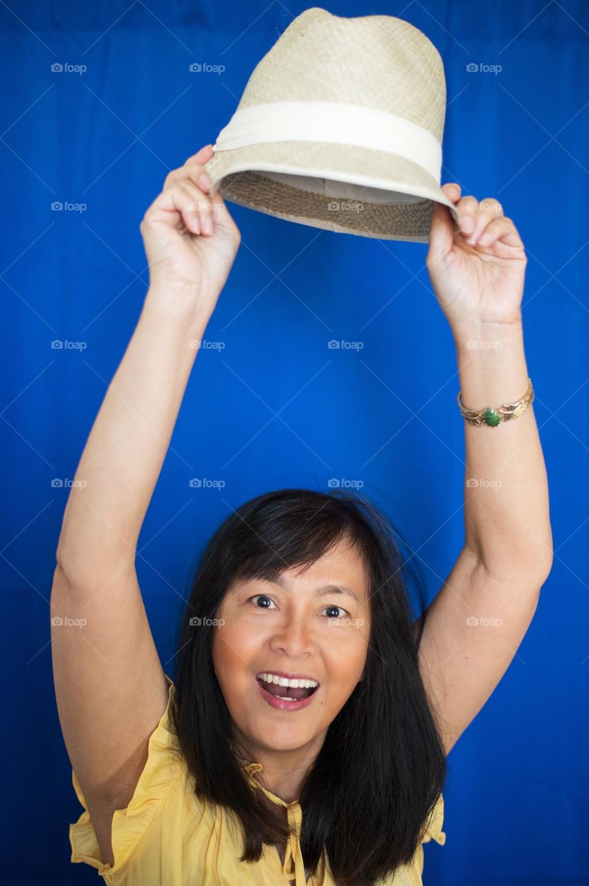 Portrait of a woman having fun with her hat