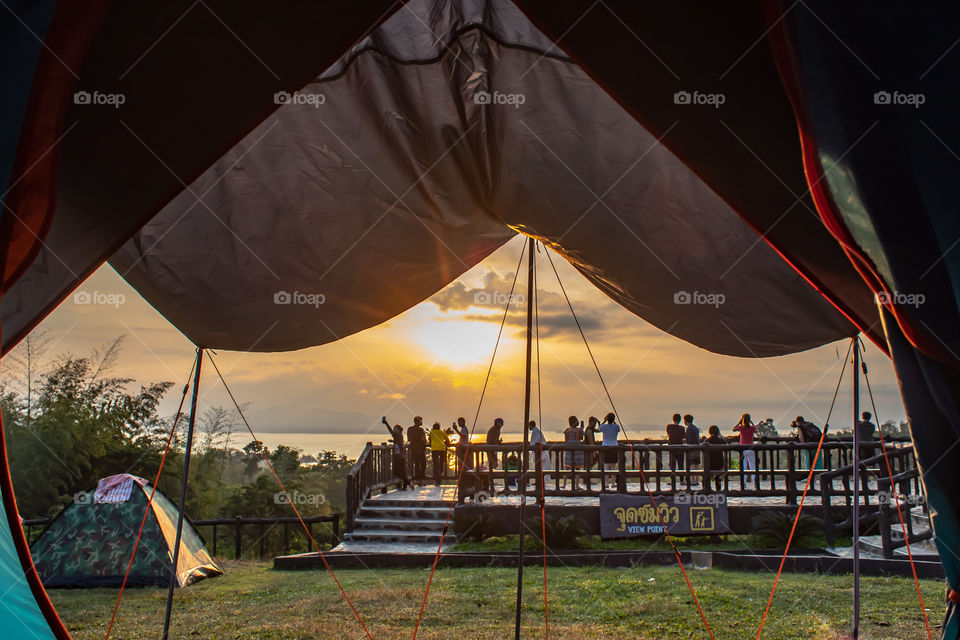 Tourists photograph sunrise over Si Nakharin dam at Huay Mae khamin waterfall National Park ,Kanchana buri in Thailand. December 2, 2018