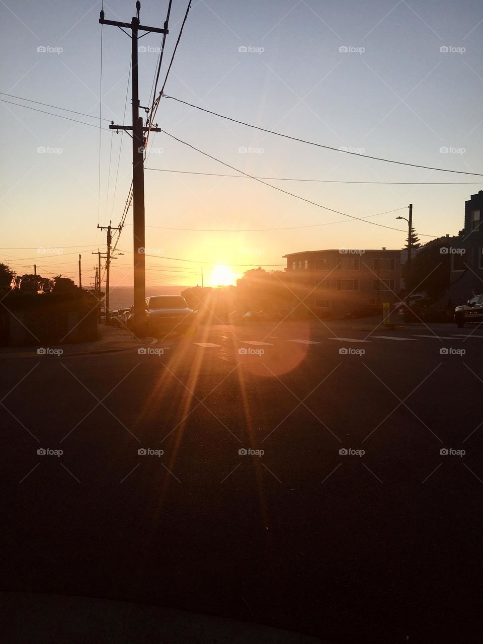 Sunset over the ocean seen in distance