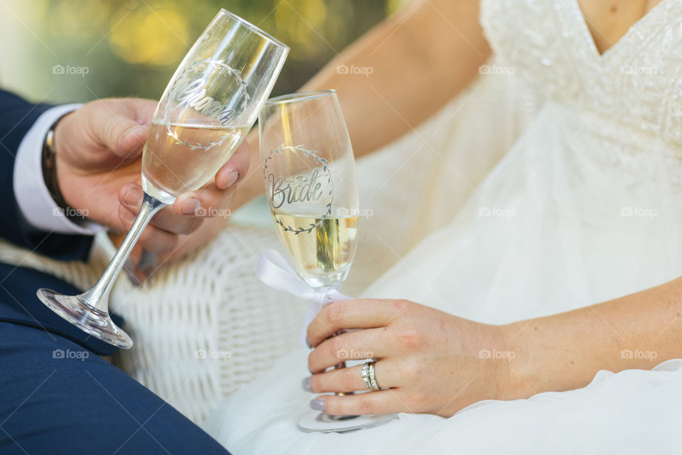 Bride and groom holding champagne glasses