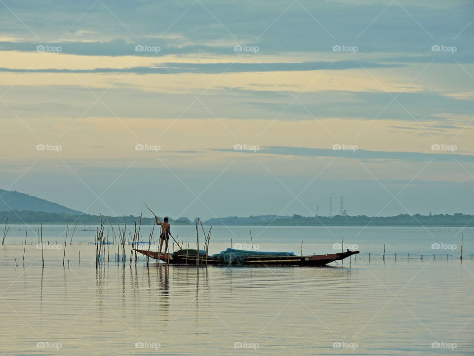 fisherman with a boat in a lake