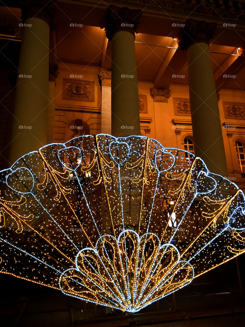Moscow in the evening.  New Year street decorations.  A huge fan of luminous garlands in front of the Bolshoi Theater