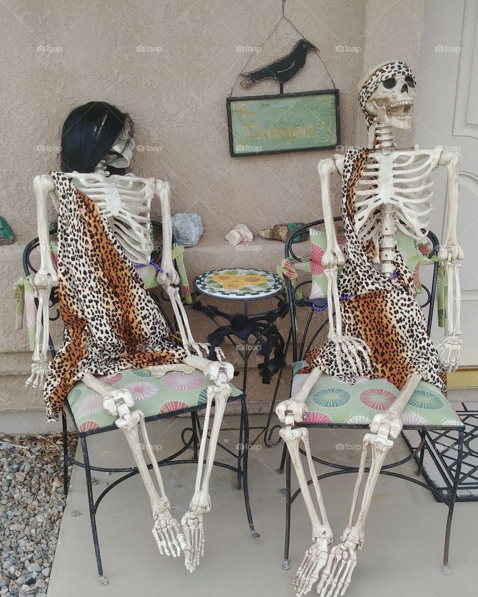 Skeleton couple dressed for Halloween outside