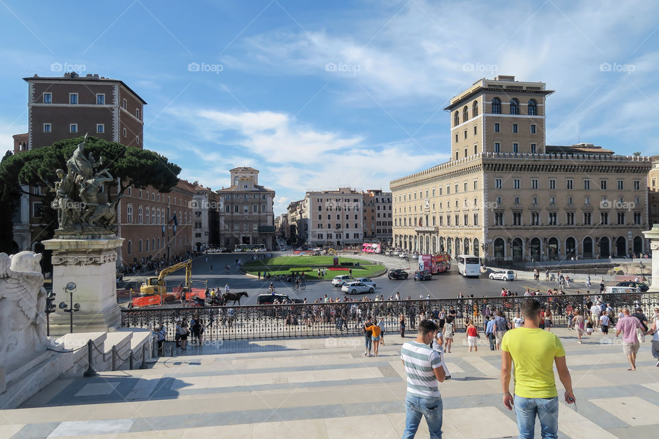 Tourists on a sunny day on the steps of Altare della Patria at Piazza Venezia in Rome, Italy.