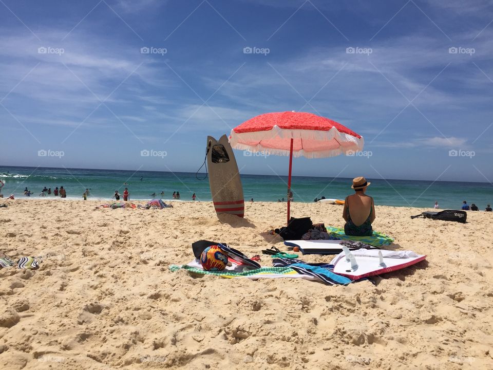 Relaxing down at the each under beach umbrella 