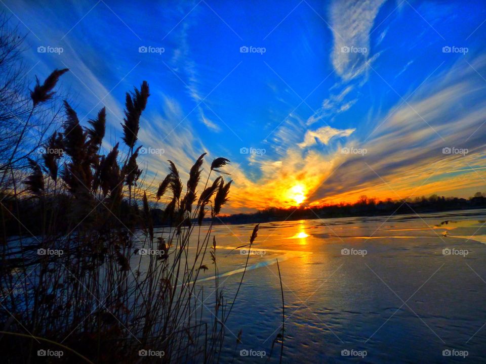 Sunset on the frozen lake. 