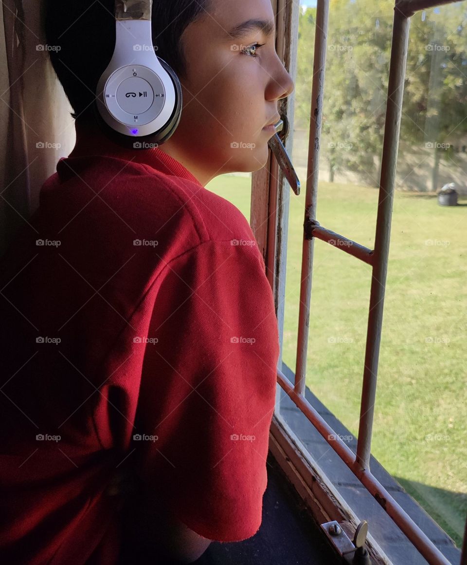 Young male looking out of the window