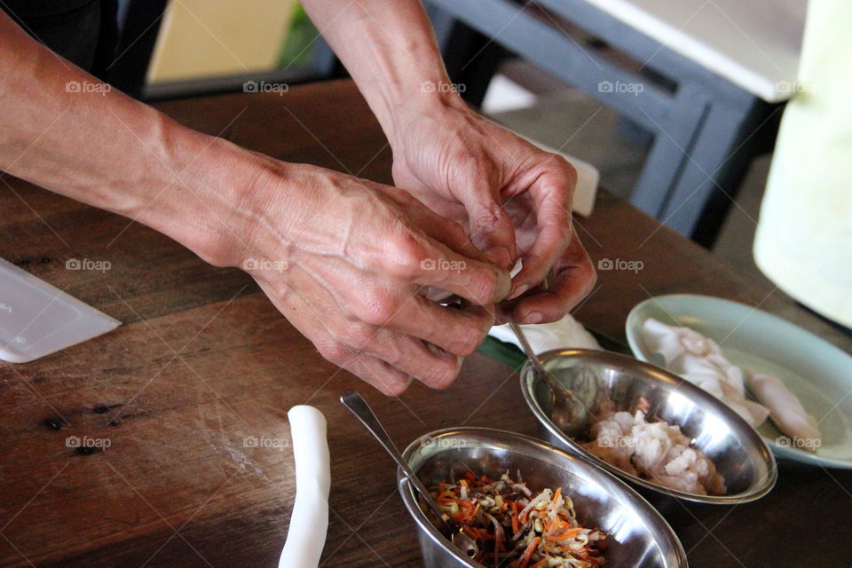 Close-up of person preparing dumplings