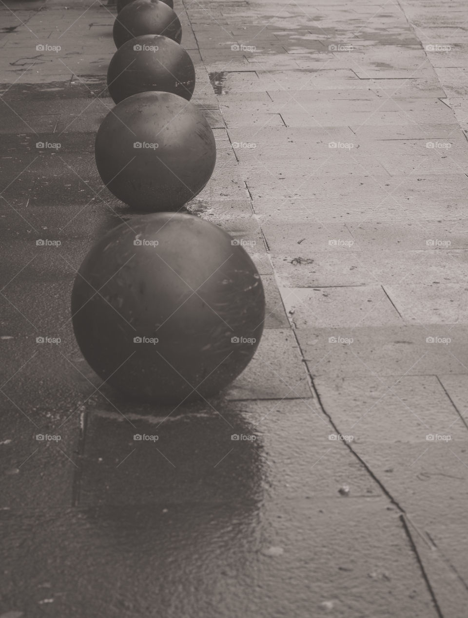 Decorative balls on the sidewalk on a rainy day of spring