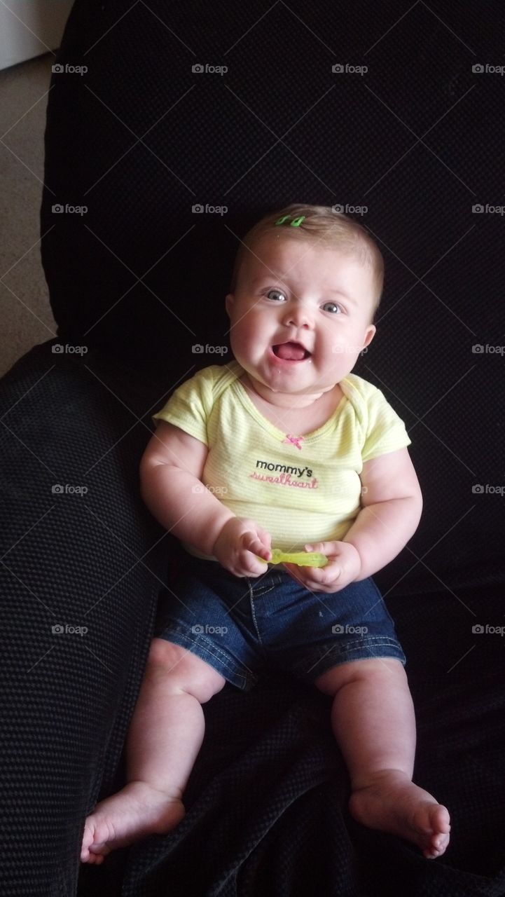 Cute baby girl sitting on chair