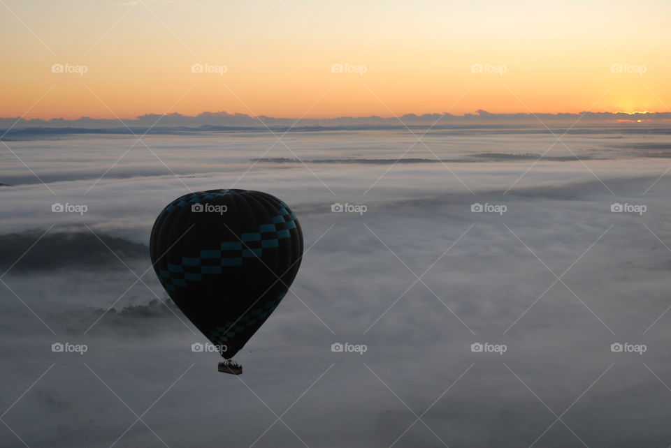 Hot Air Balloon over clouds at sunrise. Australia.