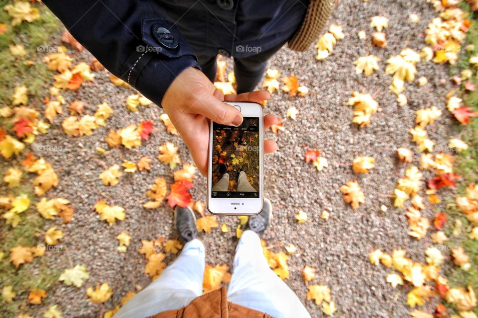 Autumn love is here. Couple feet exploring the beauty of the fall season