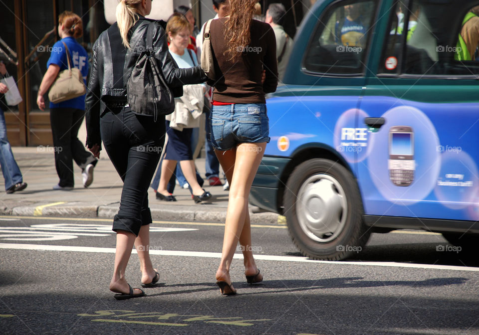 Women crossing street. London. UK.