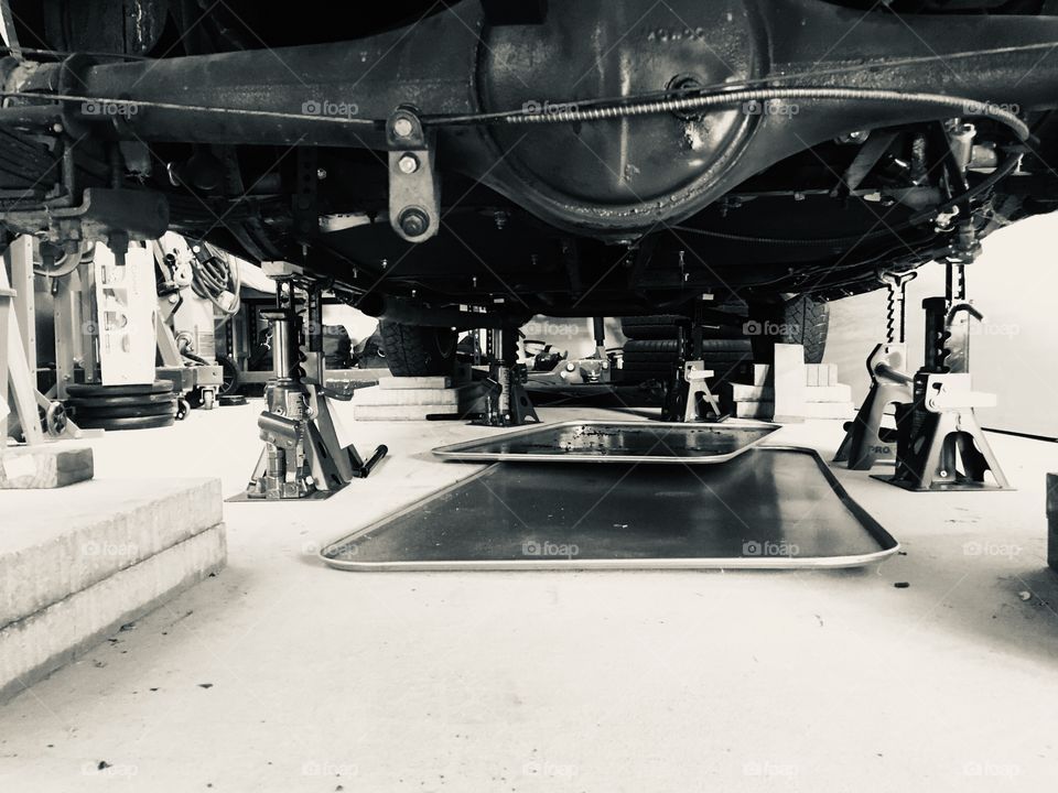Working on classic car, underside, jacks, axle