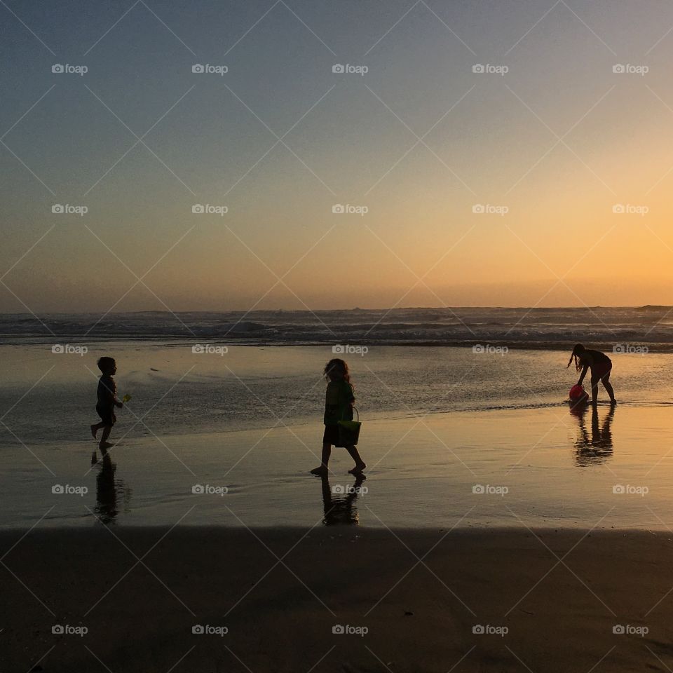 Children at sunset on the beach at sunset