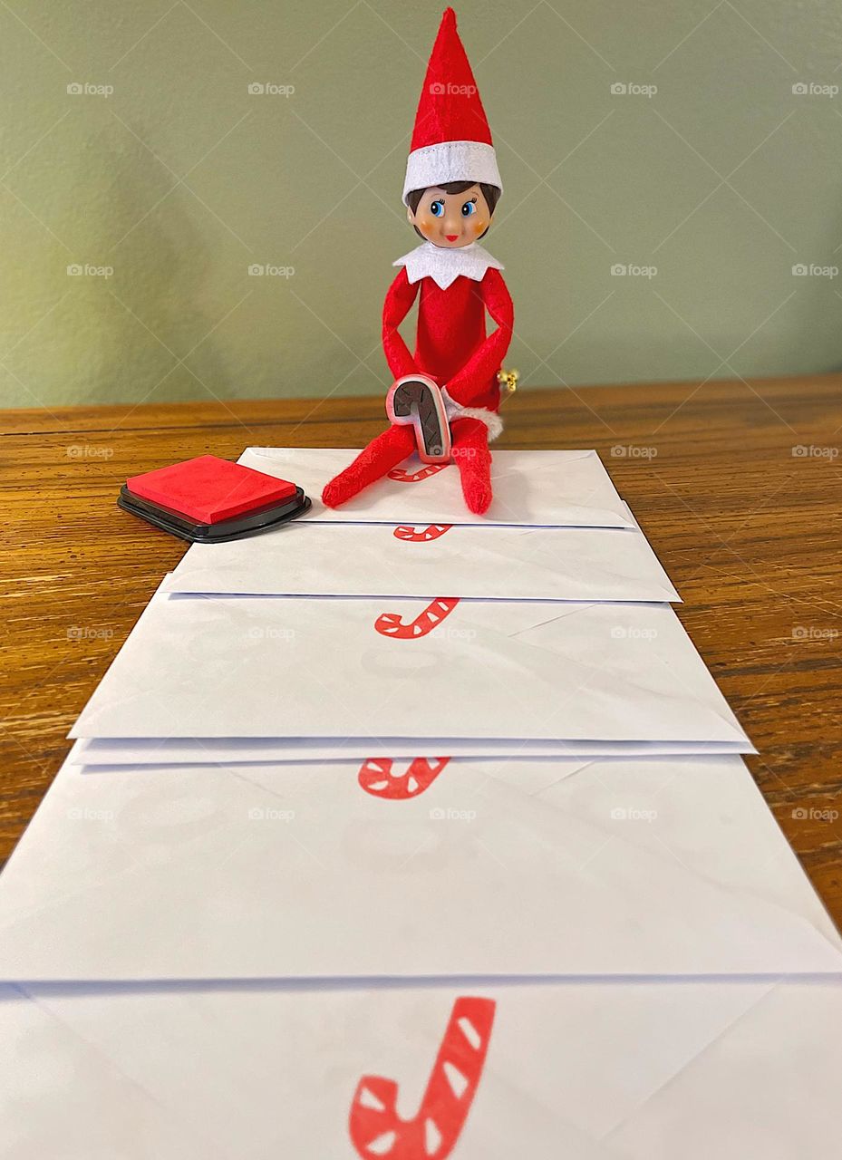 Elf on a shelf helps mail out Christmas cards, elf on a shelf antics, elf helps around house, elf on a shelf traditions