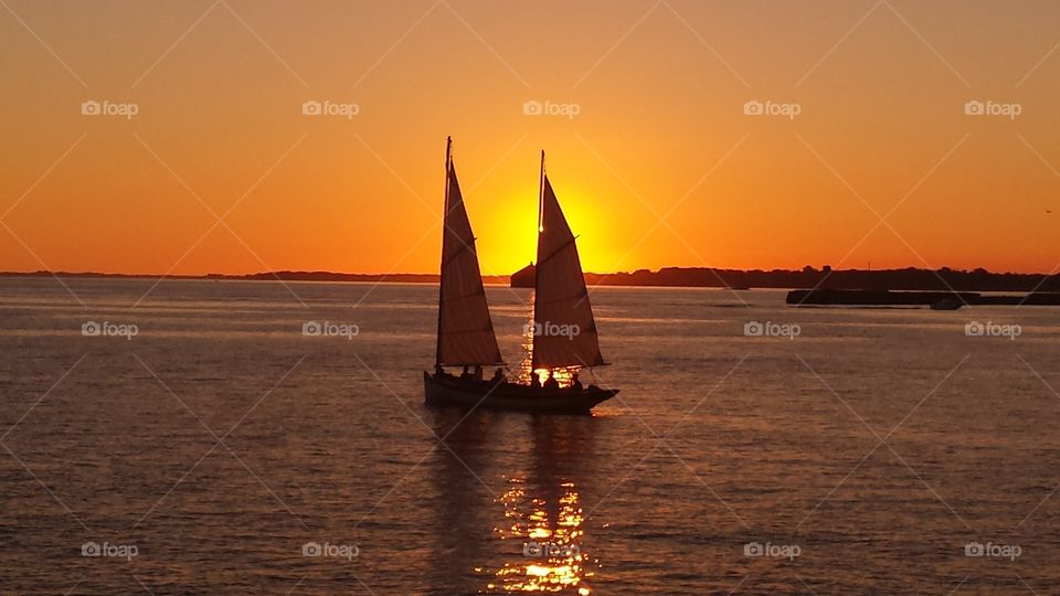 boat trapped in sunset,. sunset in harbor erie basin marina buffali inner harbor