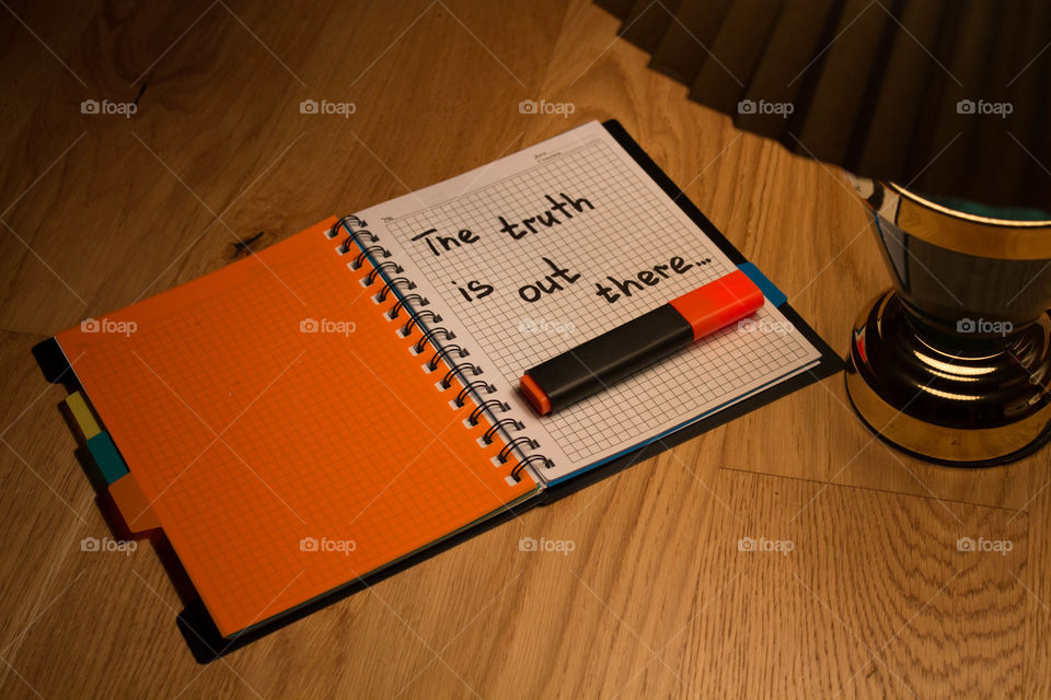 Motivational letter in a notebook on the desktop under the light of a lamp