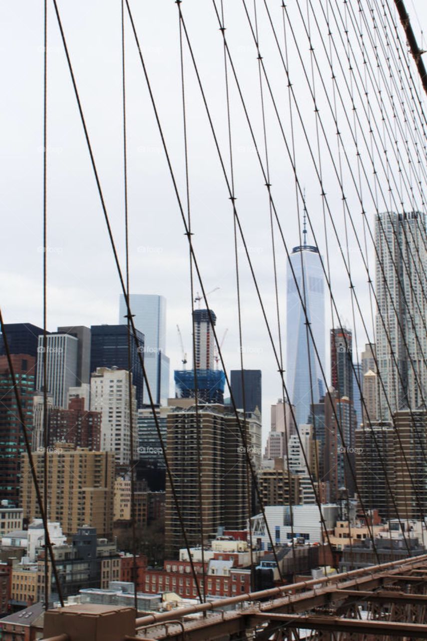New York City through wires on bridge 