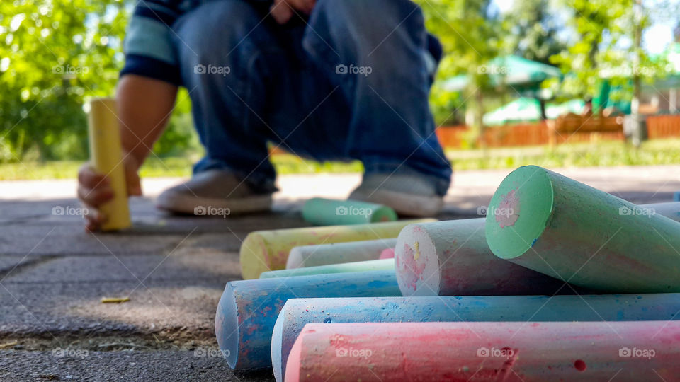 A child drawing with chalk