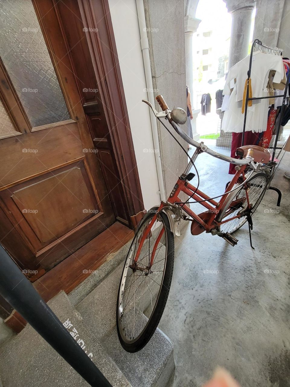 Red worn out bicycle in historic site