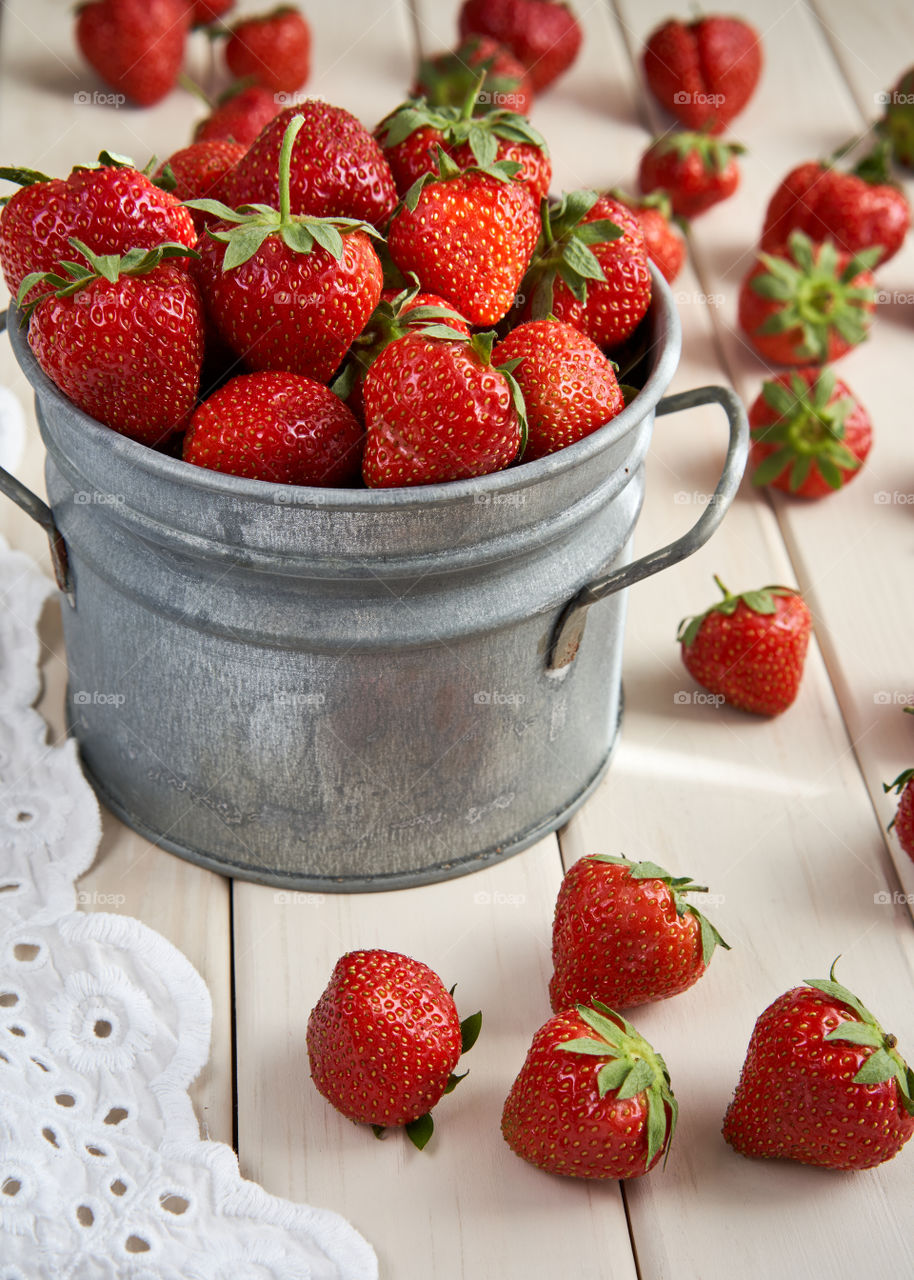 Vintage metal pail full of strawberries