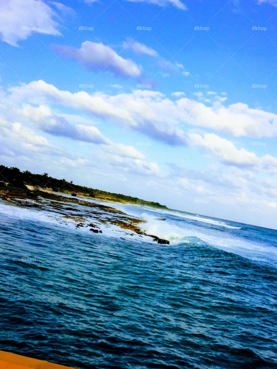 Perfectly blue waves crashing against the shore of Costa Maya.