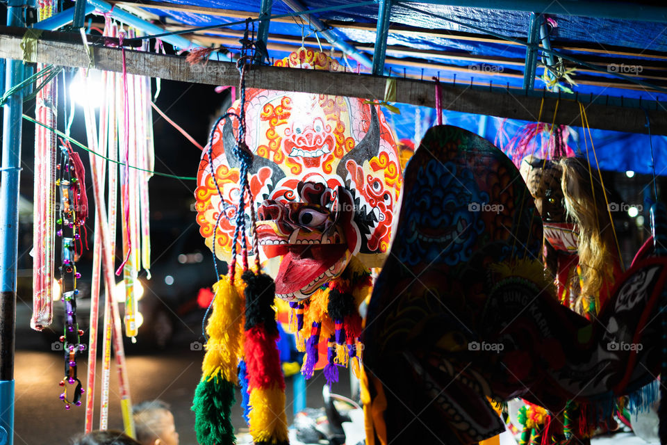 A traditional mask left hanging