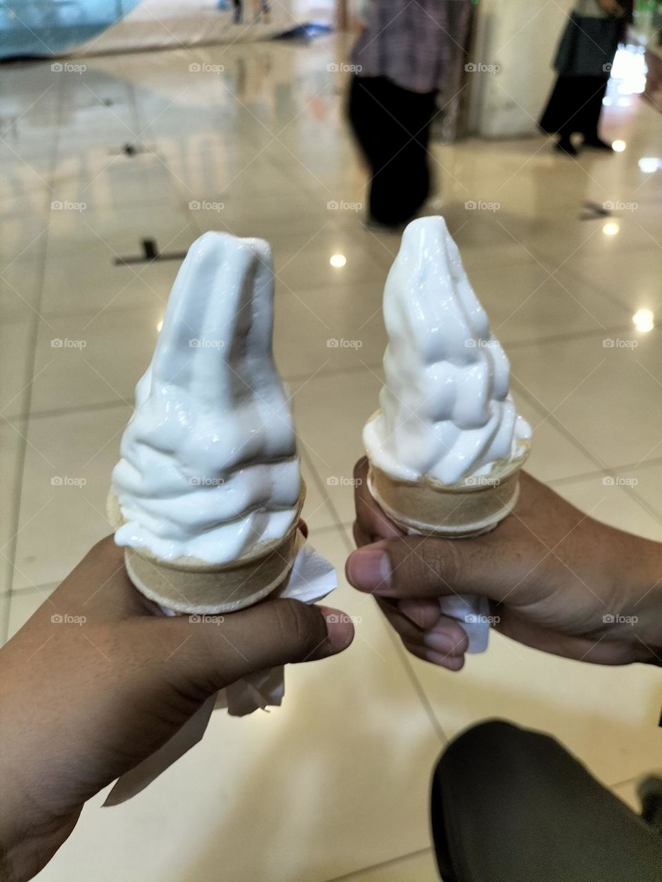 a pair of hands holding an ice cream