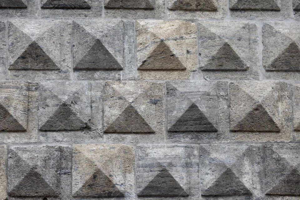 Triangles wall made of granite stone