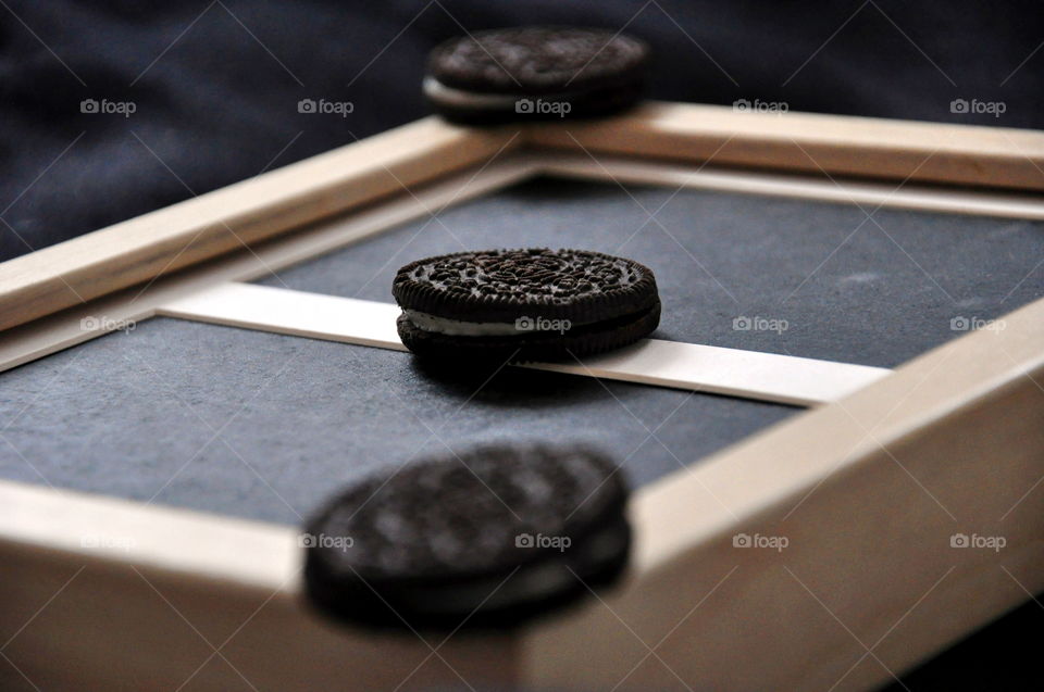 oreo three cookies black and white on wooden photo frame still live close up