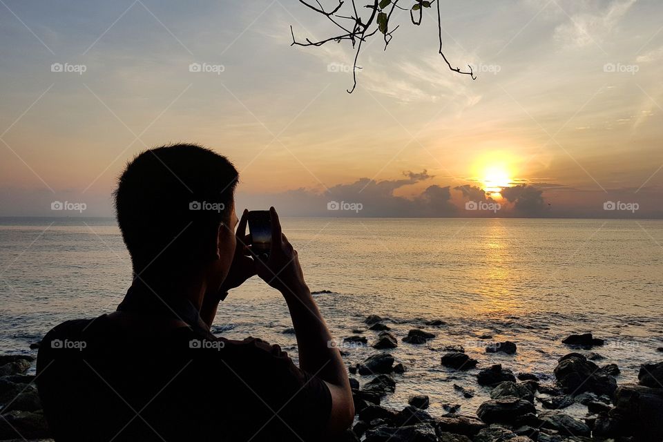 Man and runrise at beach
