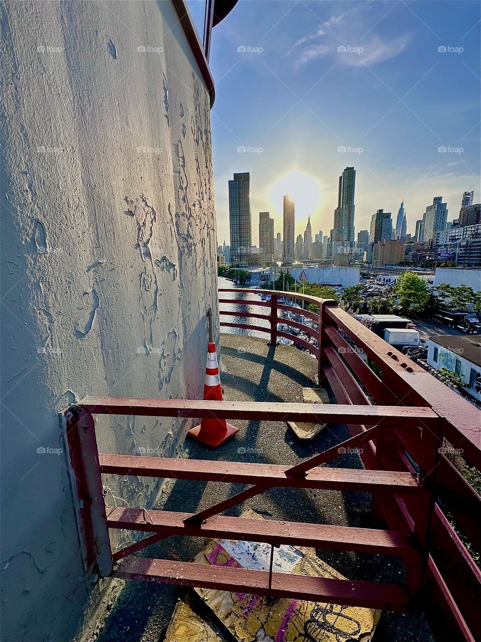 This is “Newtown Creek” seen from the center outpost of the “Pulaski Bridge” that connects LIC, Queens to “Greenpoint”, Bklyn. In the distance across the “E River” we see “Manhattan” including the “Empire State Building”. 2024. Hypnotic Productions