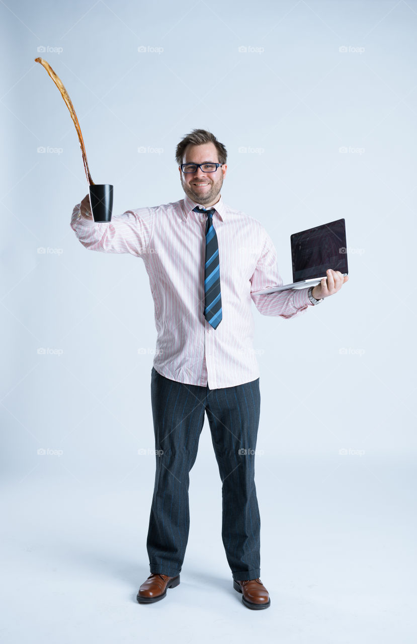 Man holding coffee mug and laptop on white background
