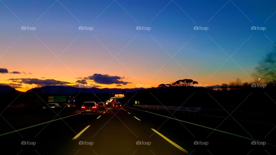 Highway sunset in Italy, going in room Roma Direction A1 highway.  winter travel