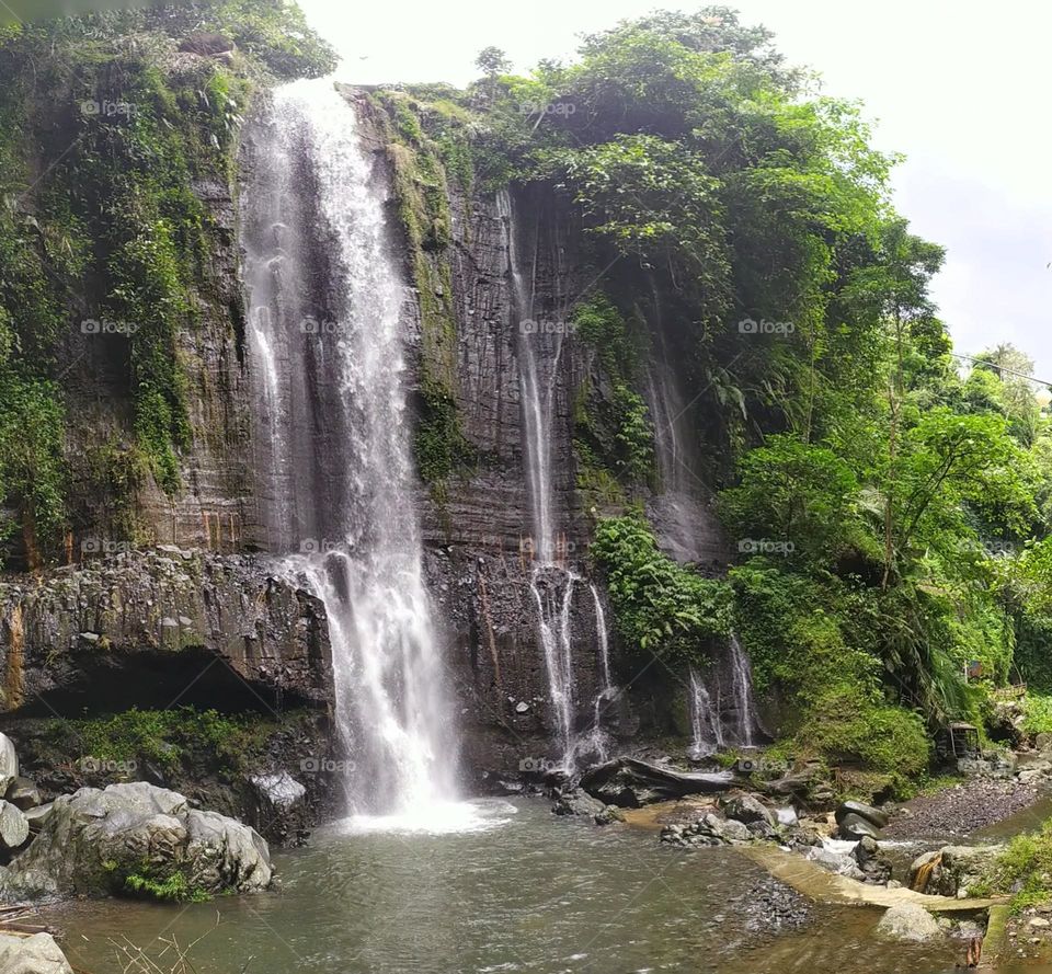 Waterfalls and large rocks at the Batu Mahpar tourist spot, Tasikmalaya Regency, West Java, Indonesia, on Wednesday 8 December 2021.