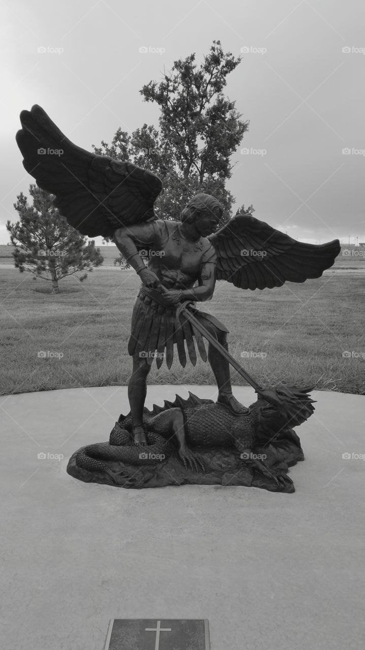Michael the arch angel defeating the enemy in battle