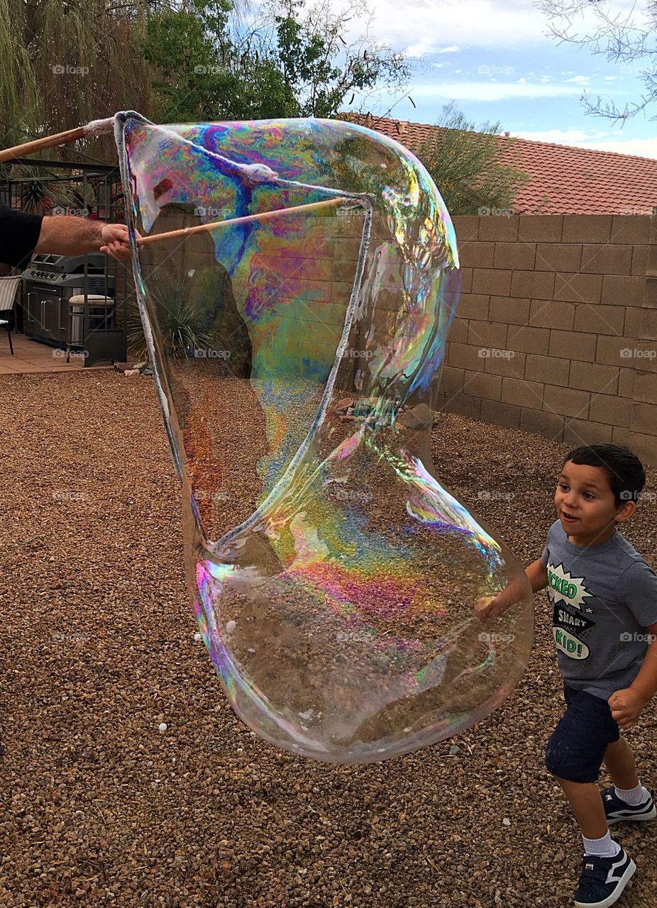 Giant bubble and a child.