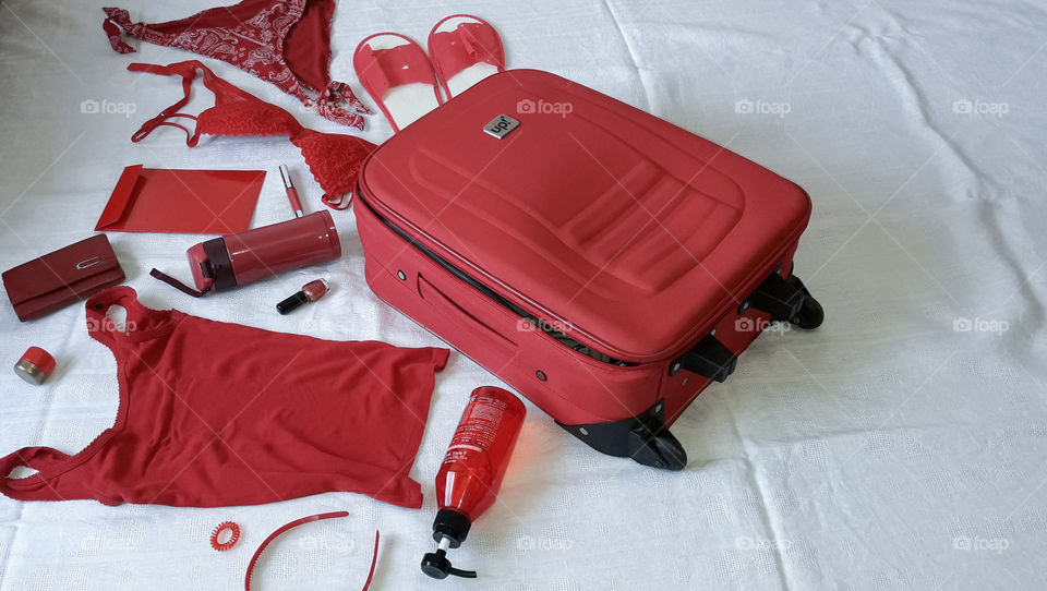 red suitcase and red clothes flatlay