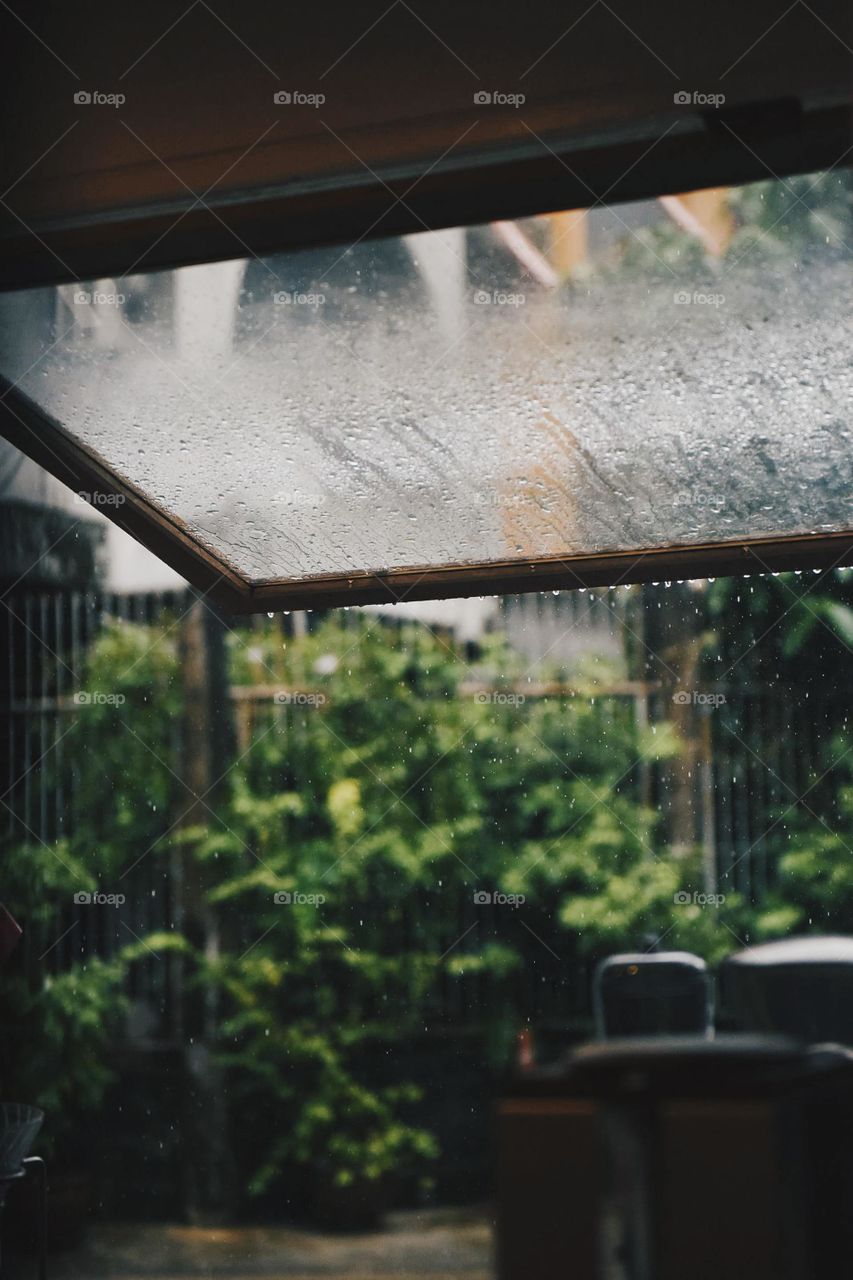 view of window glass of water drops of rain fall