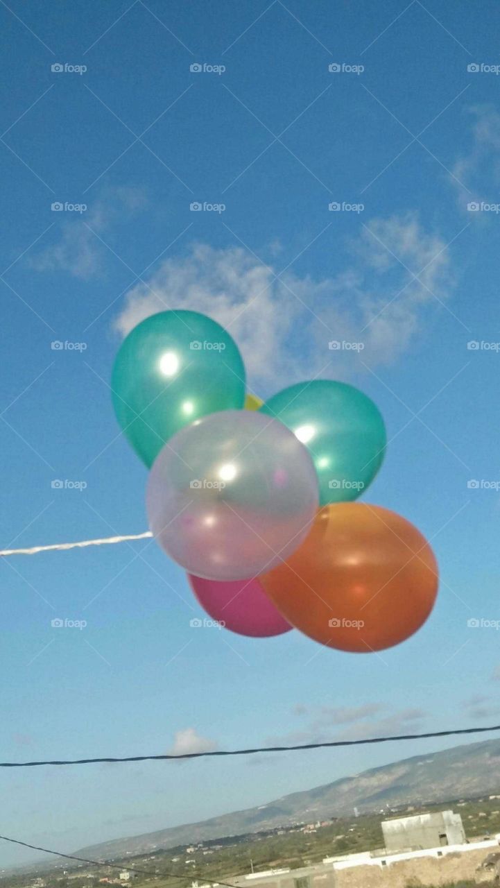 Beautiful and multicolor balloons embraced blue high sky at essaouira city in Morocco.